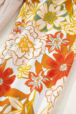 yellow and orange floral sleeve detail on beige sweater