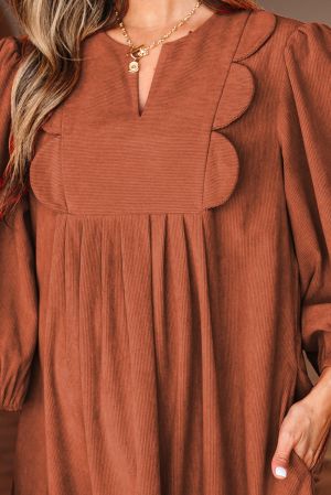 Neckline detail of cinnamon dress with decorative front elements
